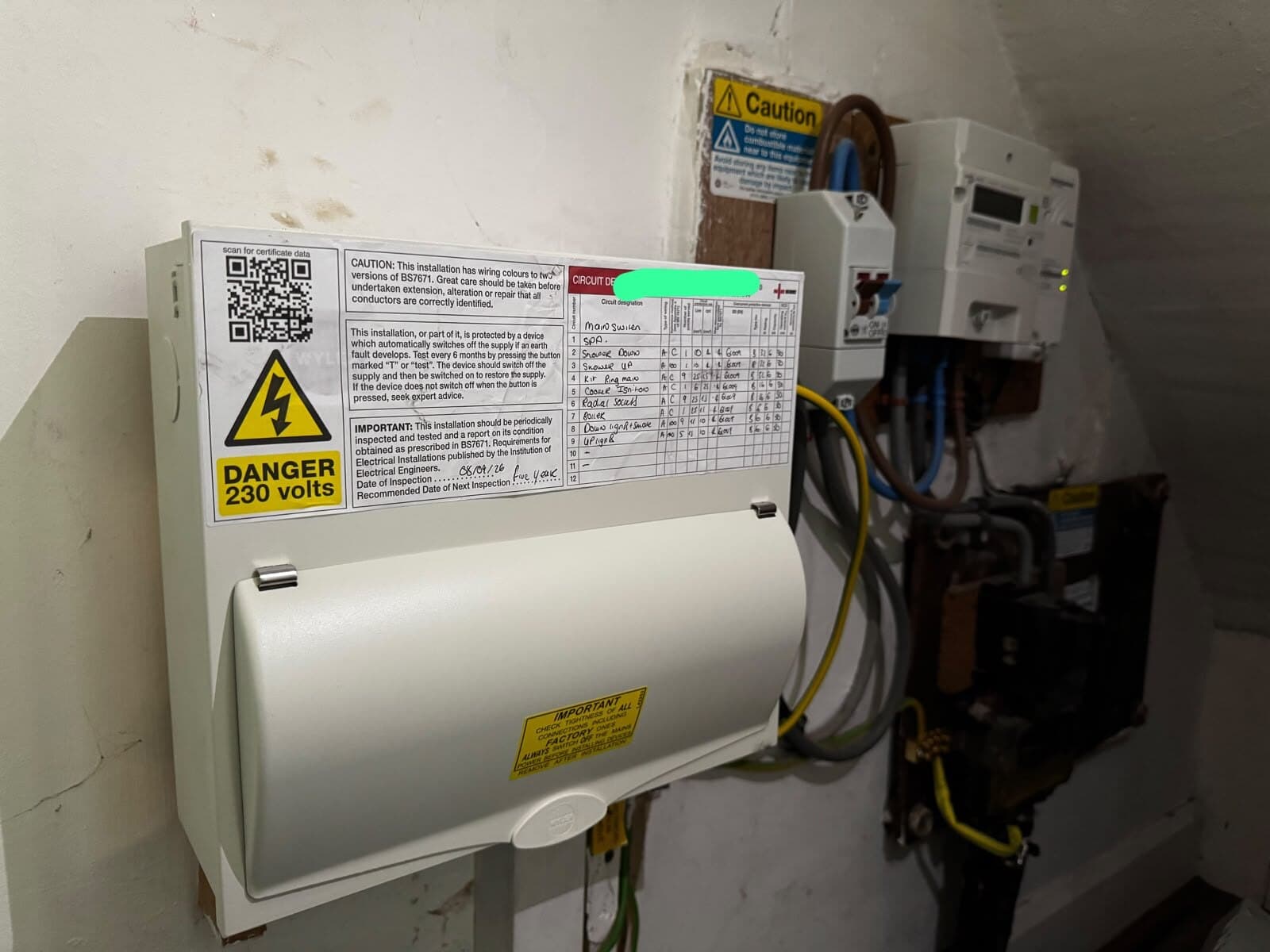 New consumer unit fitted and fully labelled next to the meter, with the test record filled in on the front